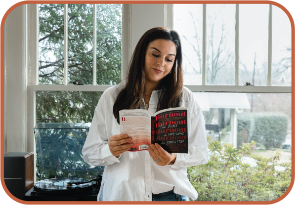 ADHD therapist Alexis Saville reading about burnout to support clients and herself