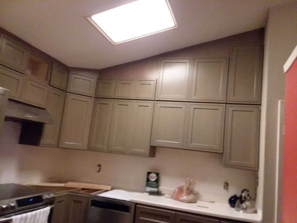 Kitchen with light-colored cabinets, white countertops, stainless steel appliances, and a recessed ceiling light.