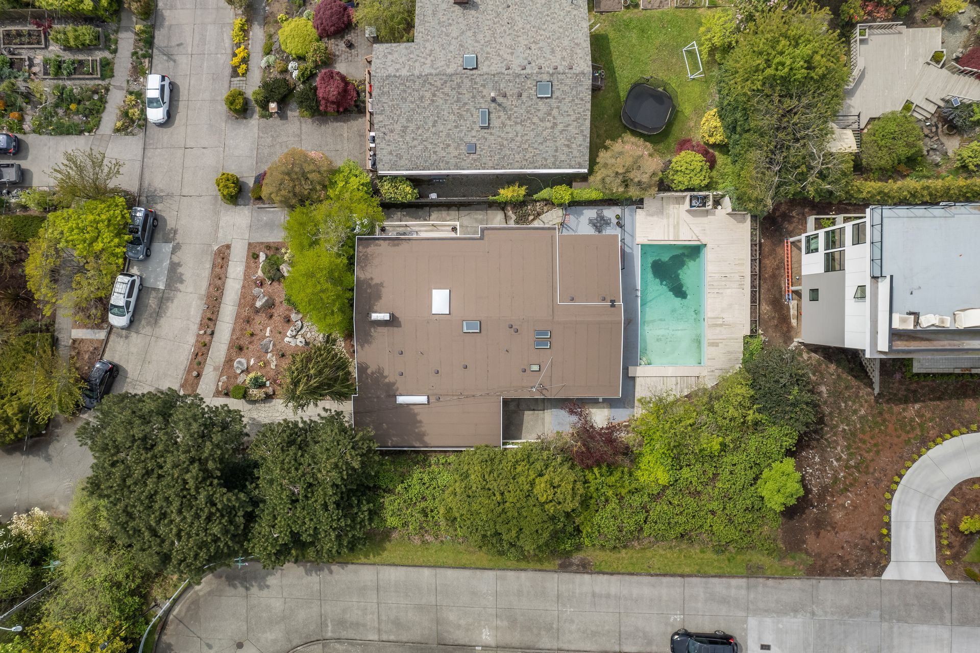 An aerial view of a house with a pool in the backyard