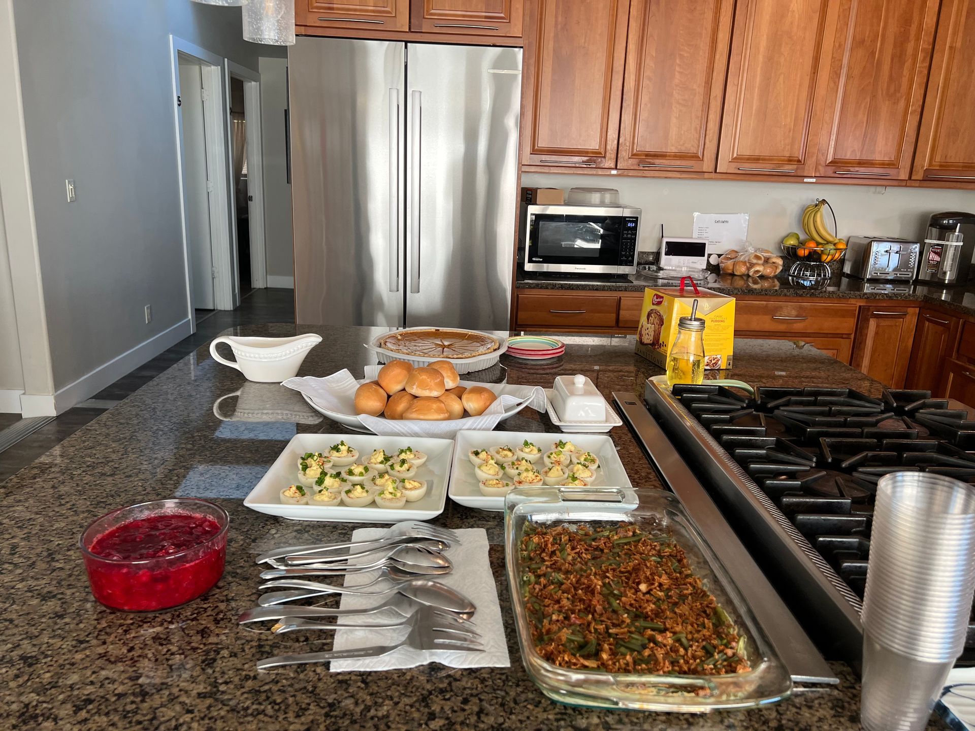 A kitchen counter with a lot of food on it