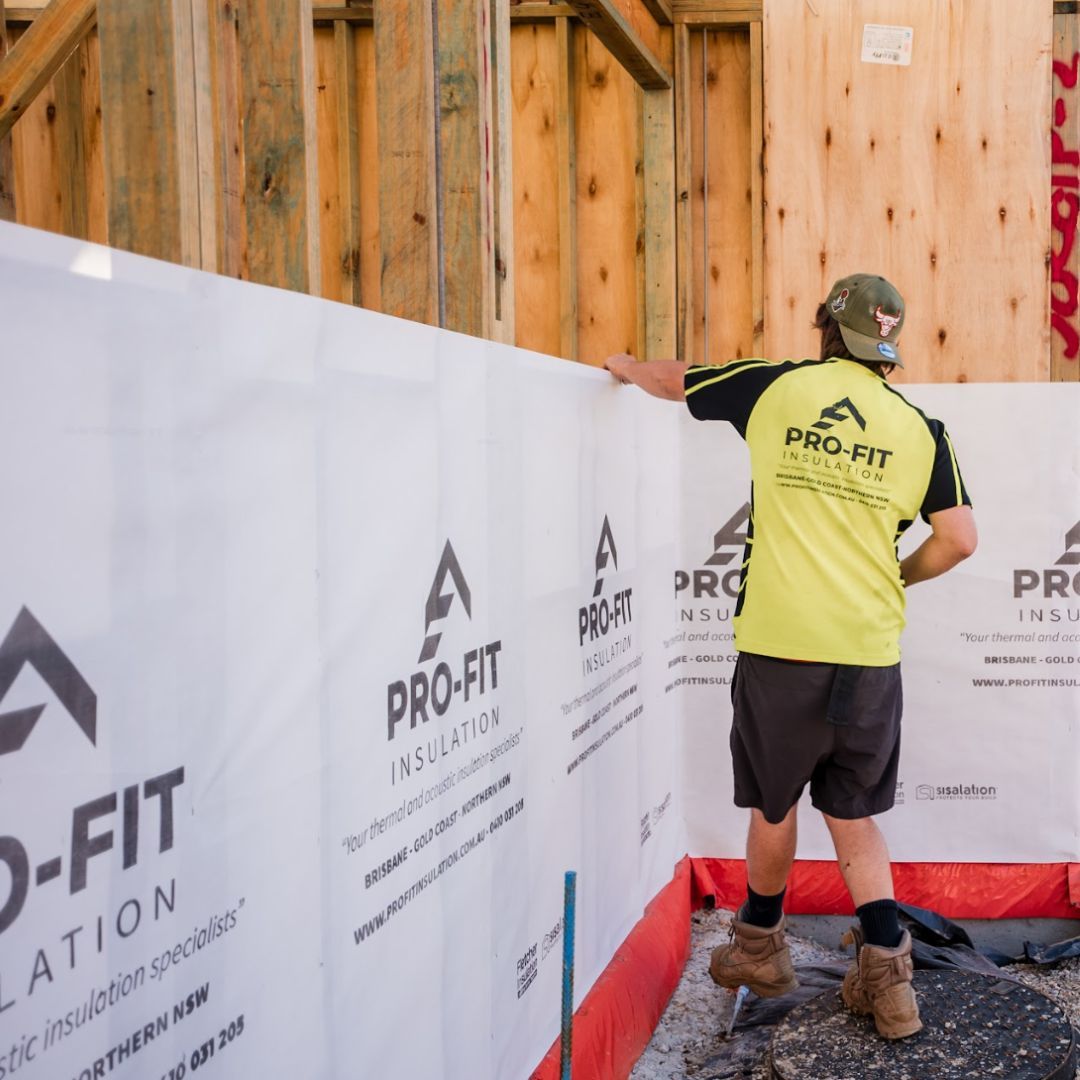A man wearing a yellow shirt that says pro-fit