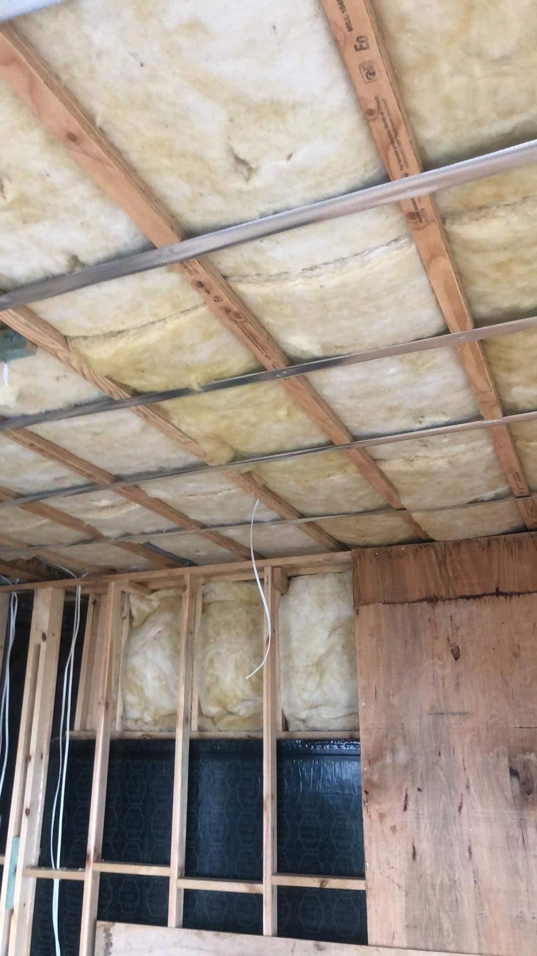 A room with a ceiling made of wood and insulation — Roof Vacuuming in Arundel QLD