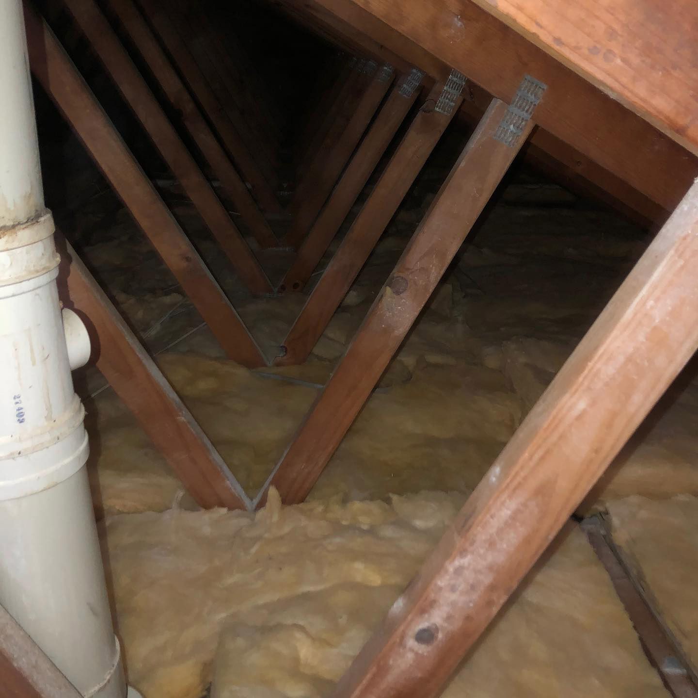 An attic with a pipe that says ' pvc ' on it — Roof Vacuuming in Arundel QLD
