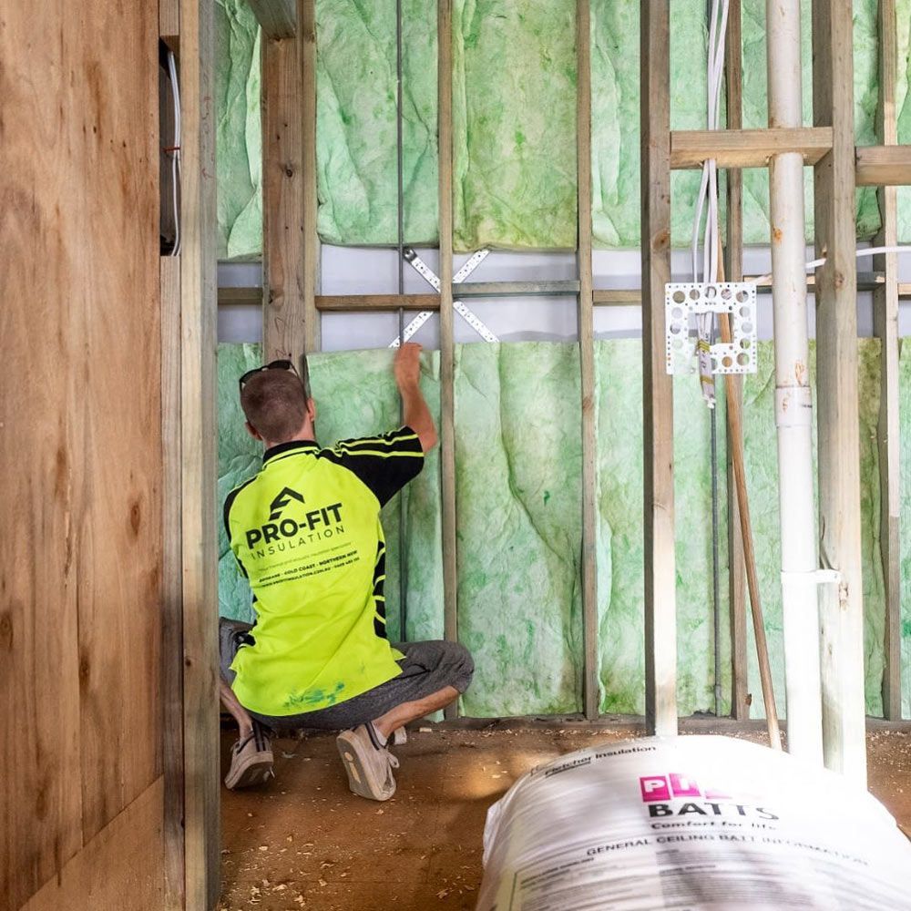 A Professional Installing An Insulation