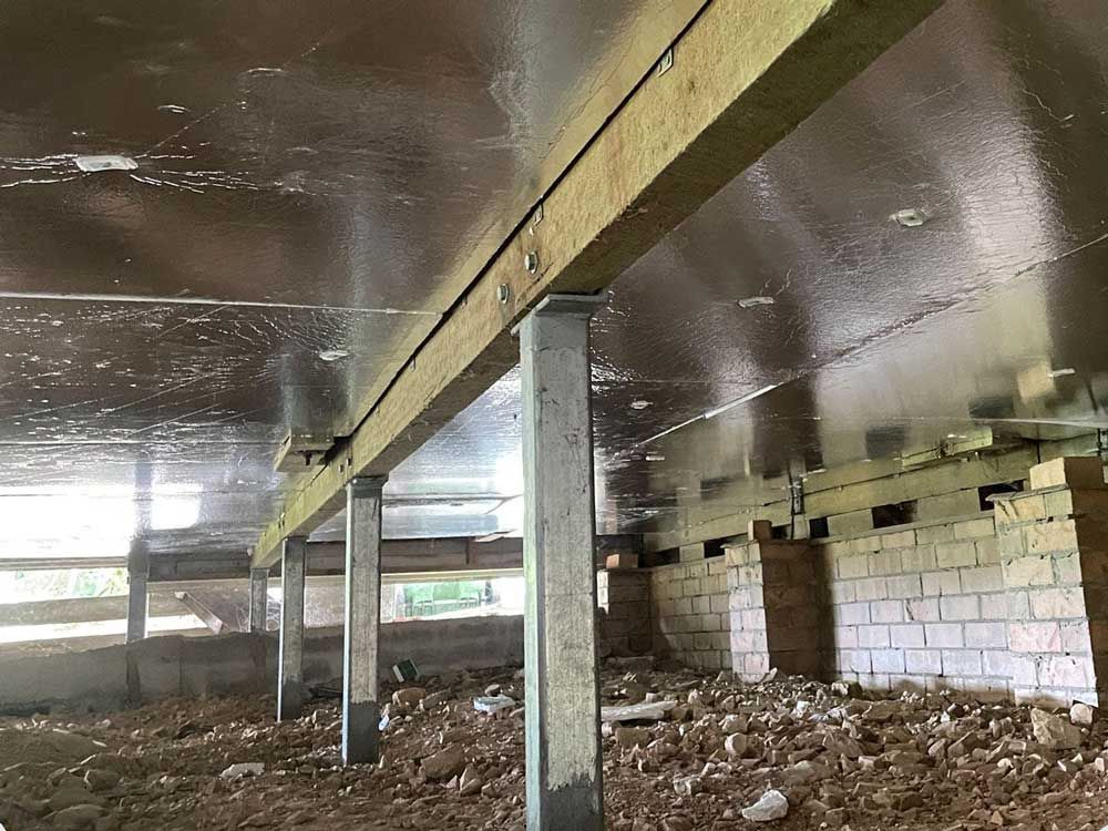 The Ceiling Of A Building Under Construction With A Lot Of Wooden Beams — Pro-fit Insulation in Arundel, QLD