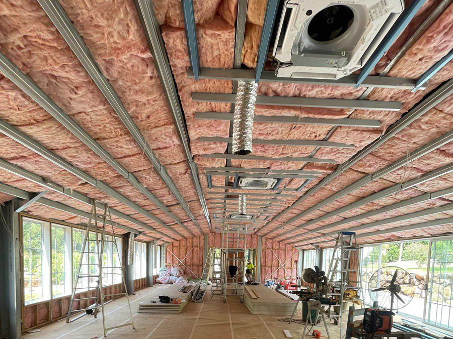 A Large Room With A Lot Of Windows And A Ceiling That Is Being Built — Pro-fit Insulation in Arundel, QLD