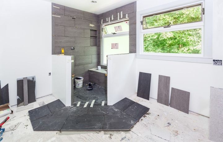 A corner-style open shower mid-installation