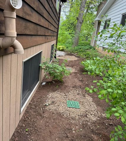 A house with a drain on the side of it