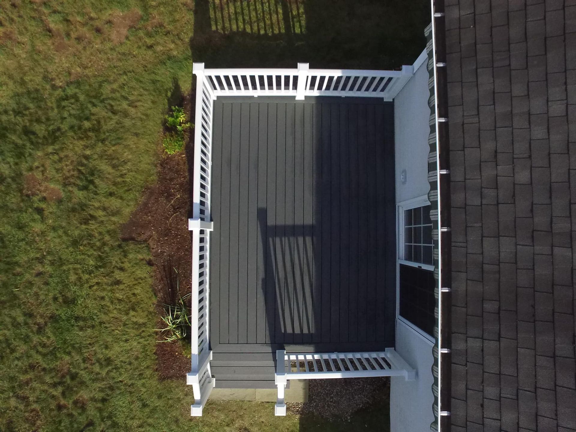 An aerial view of a deck with a white railing