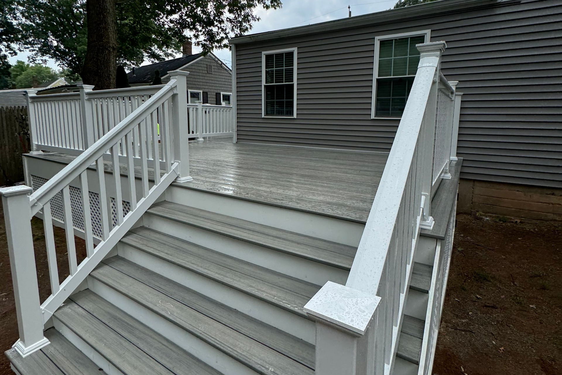 An aerial view of a deck with stairs and a white railing