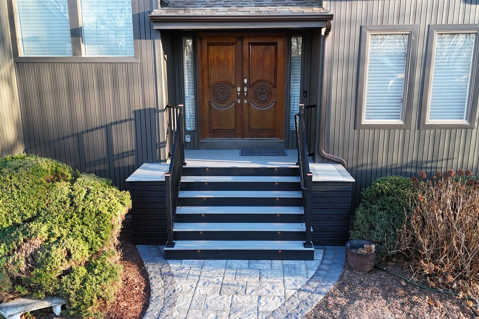 A porch with two chairs and a table on it
