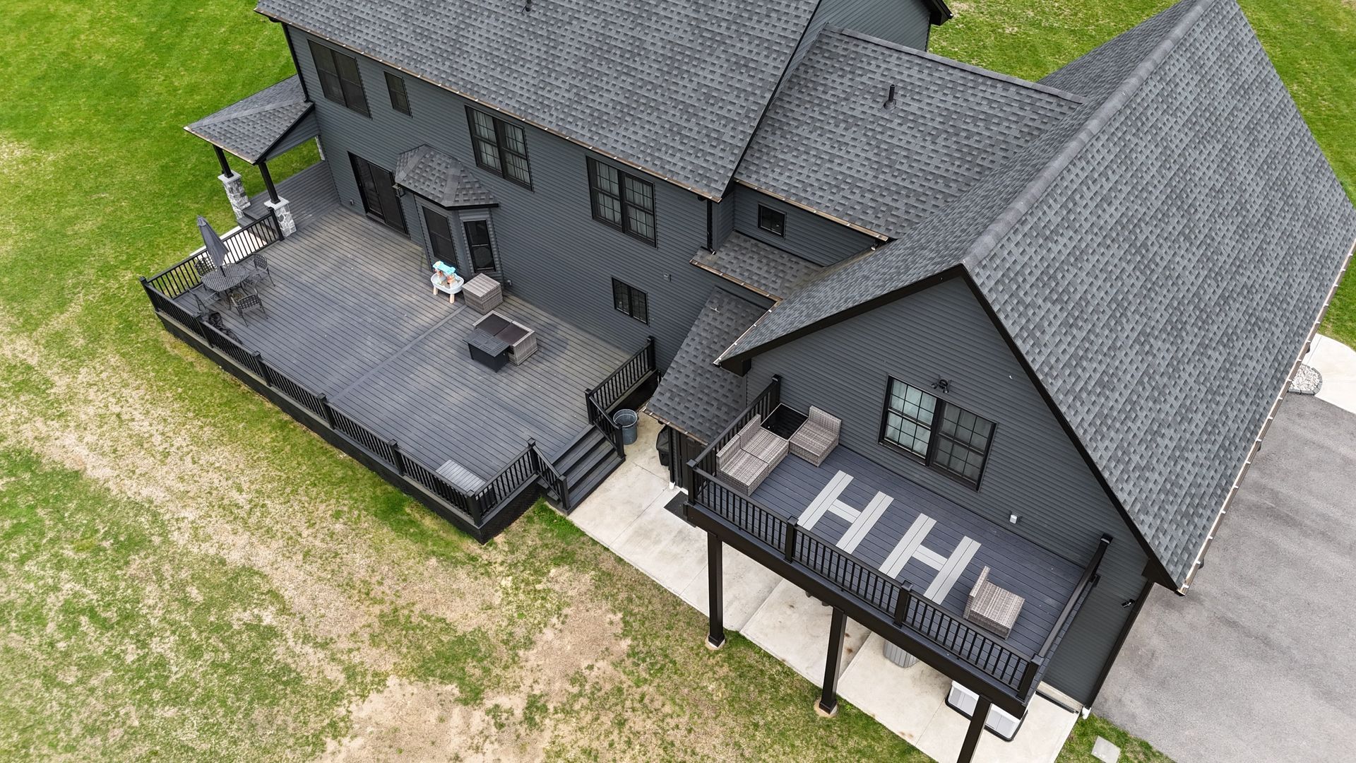 Dark gray two-story house with decks; 