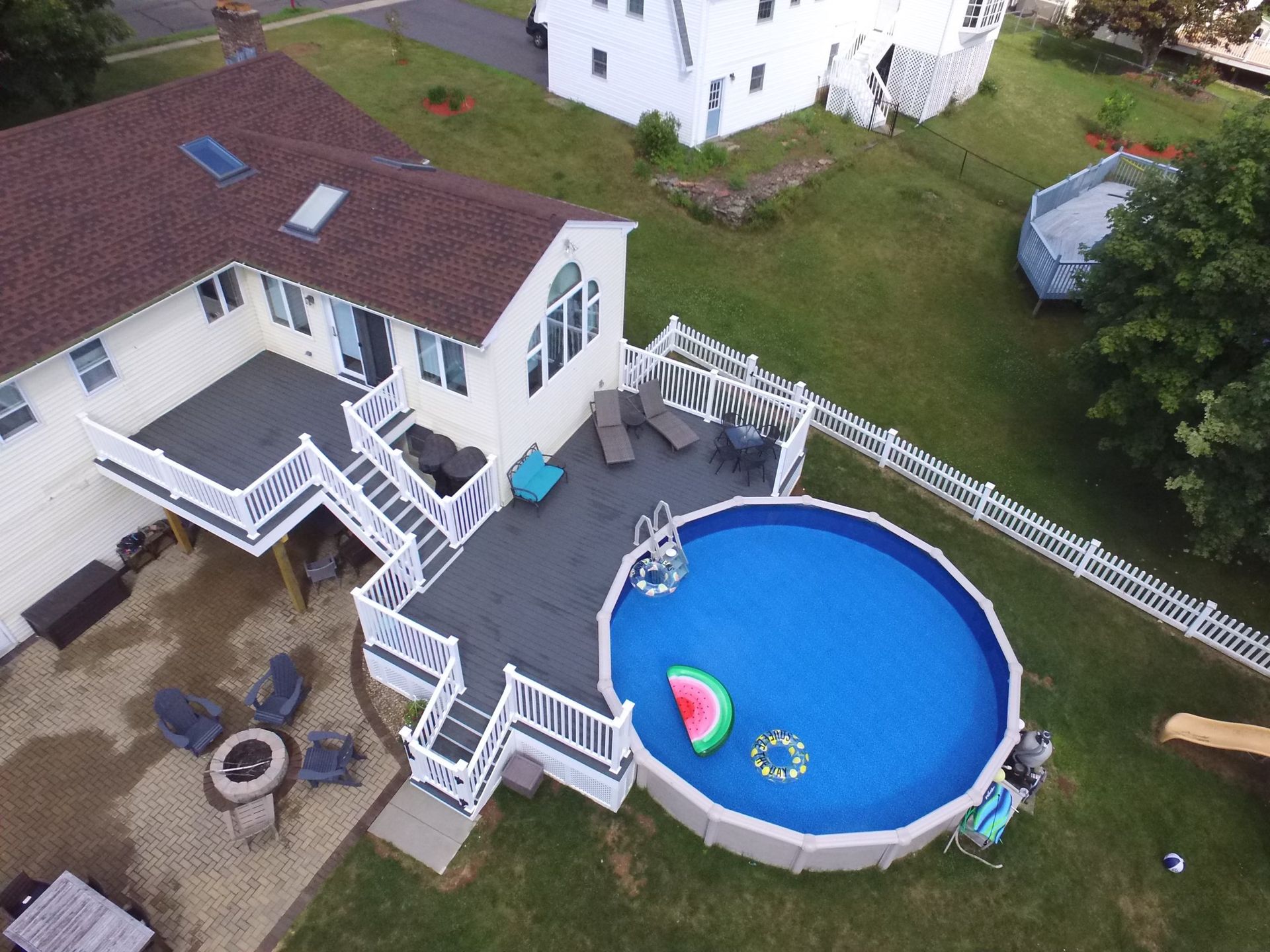 An aerial view of a house with a swimming pool in the backyard