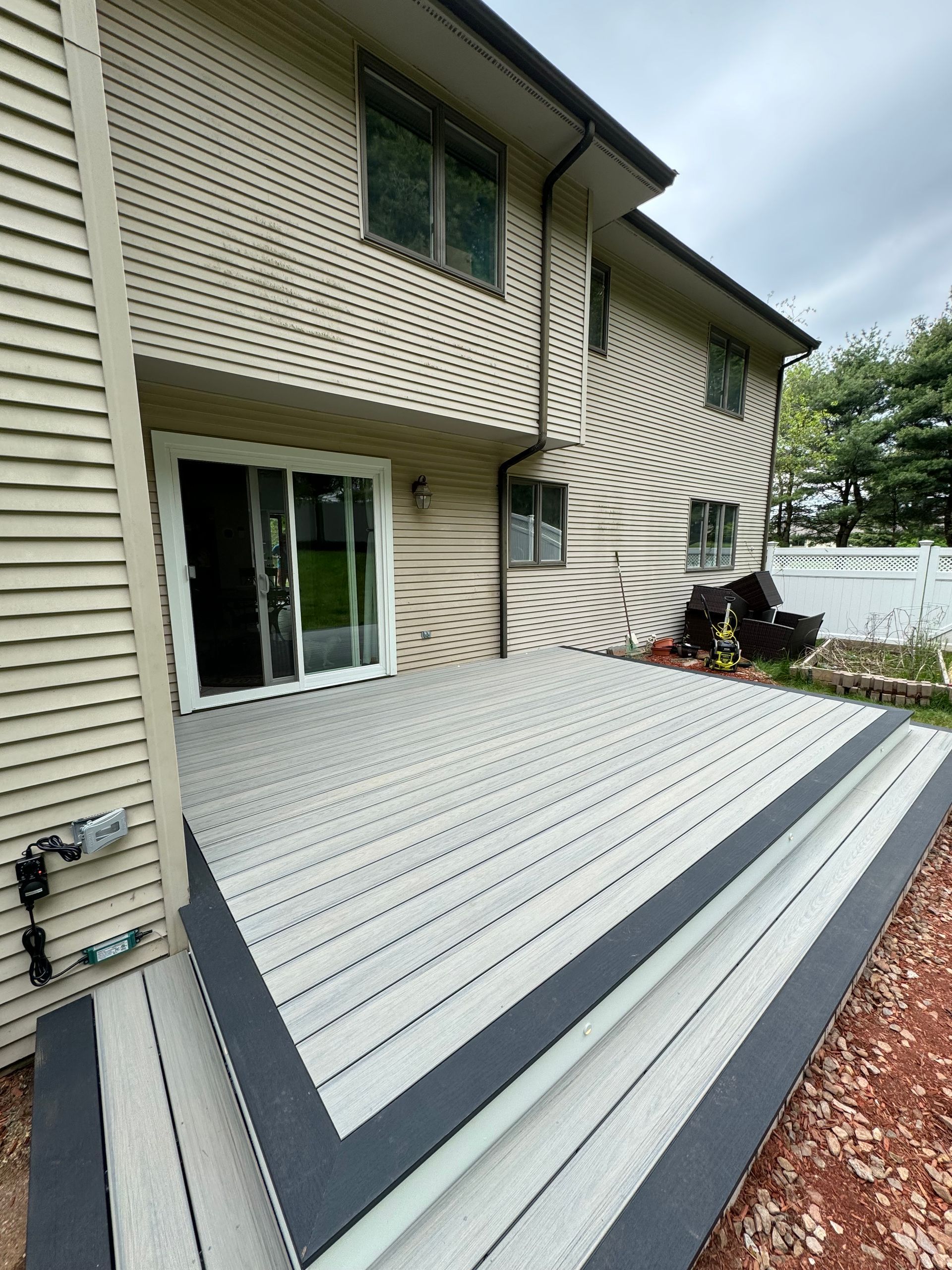 A large house with a large deck in front of it.