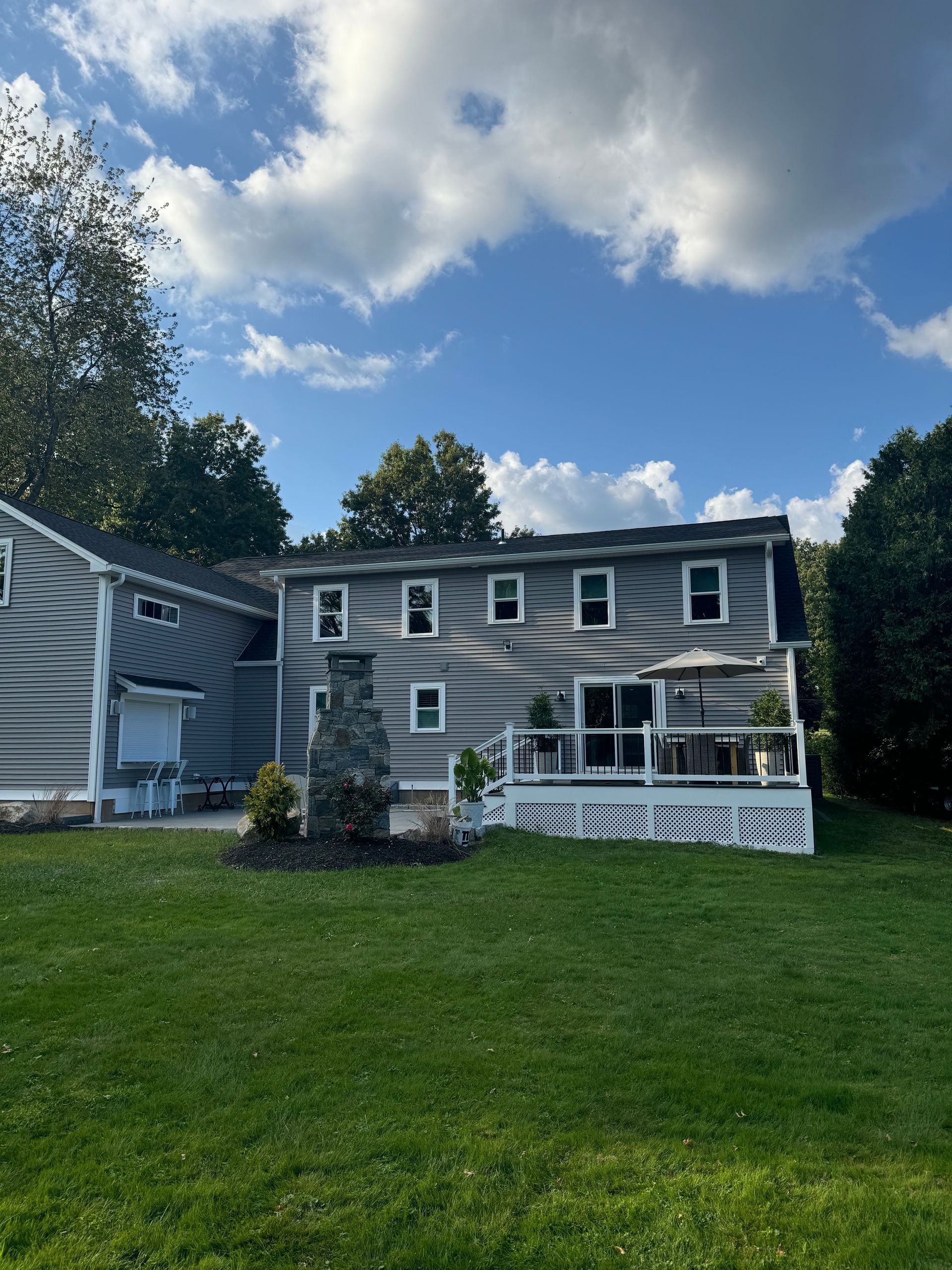The backyard of a house with a large deck