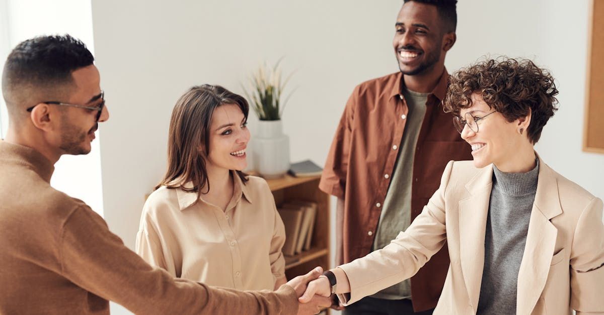 A group of people are shaking hands in a room.