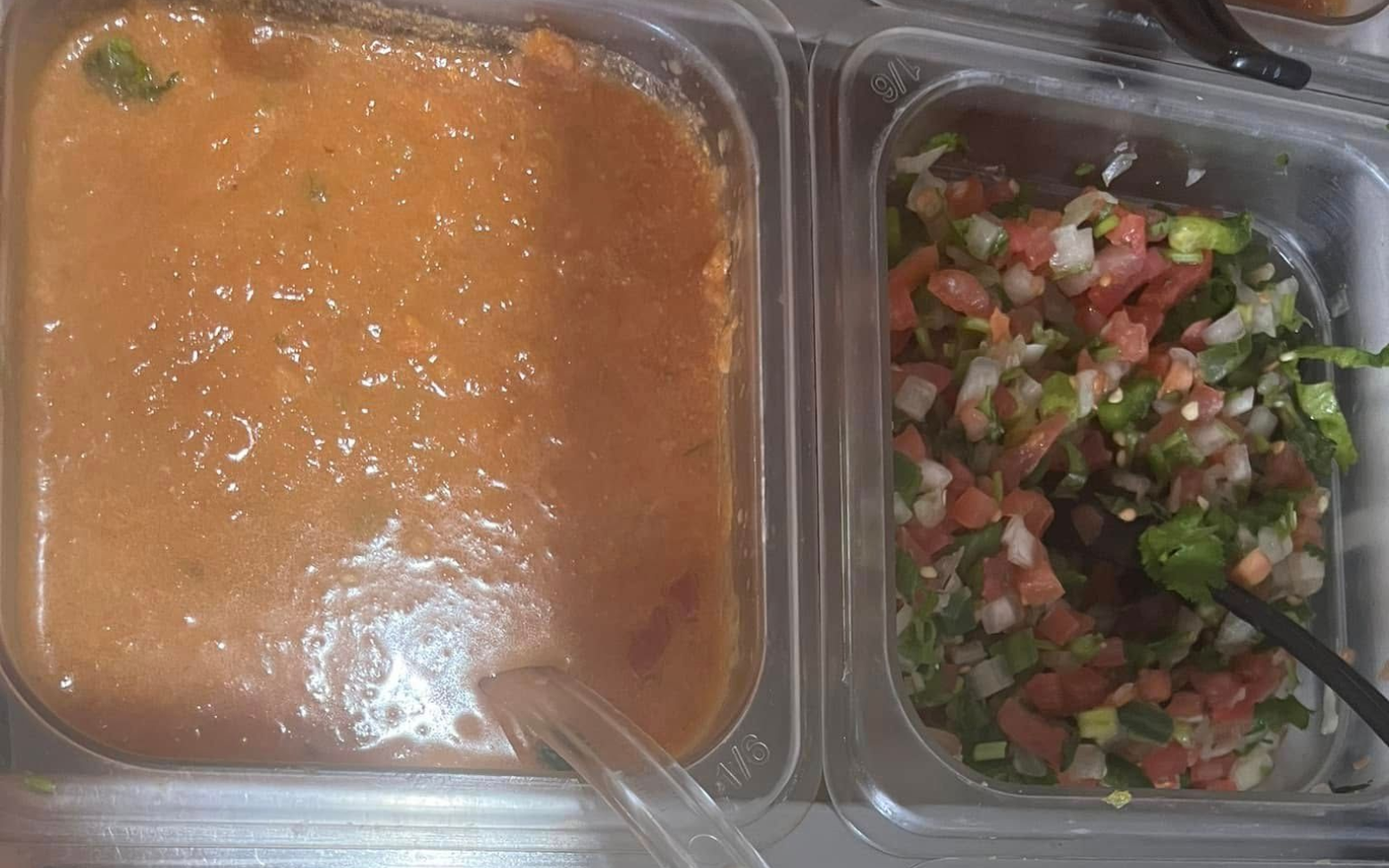 Two plastic containers hold orange sauce and diced vegetables.