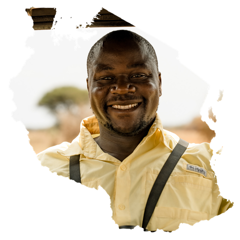 A man wearing a yellow shirt and suspenders is smiling