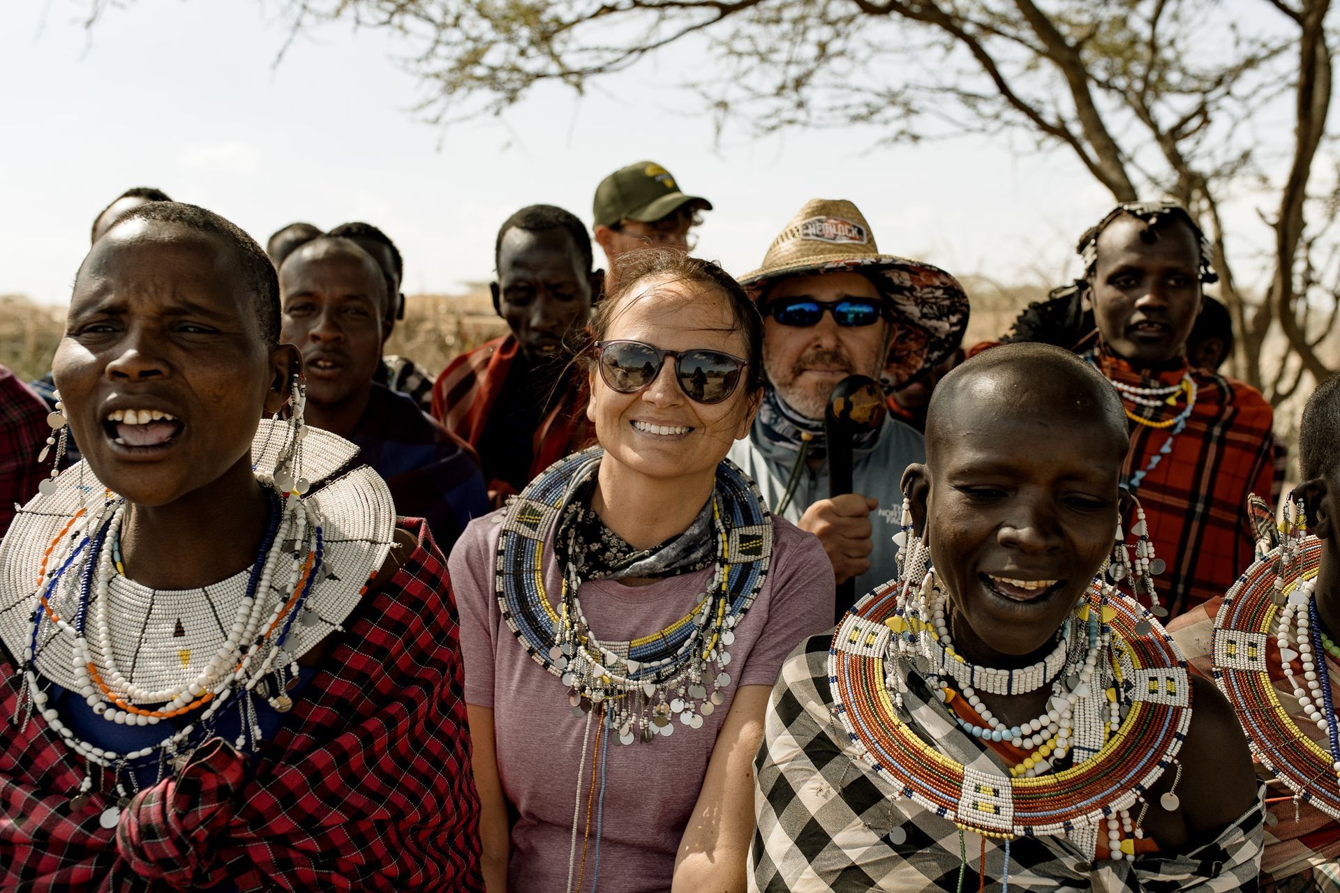A group of people are standing next to each other and smiling.