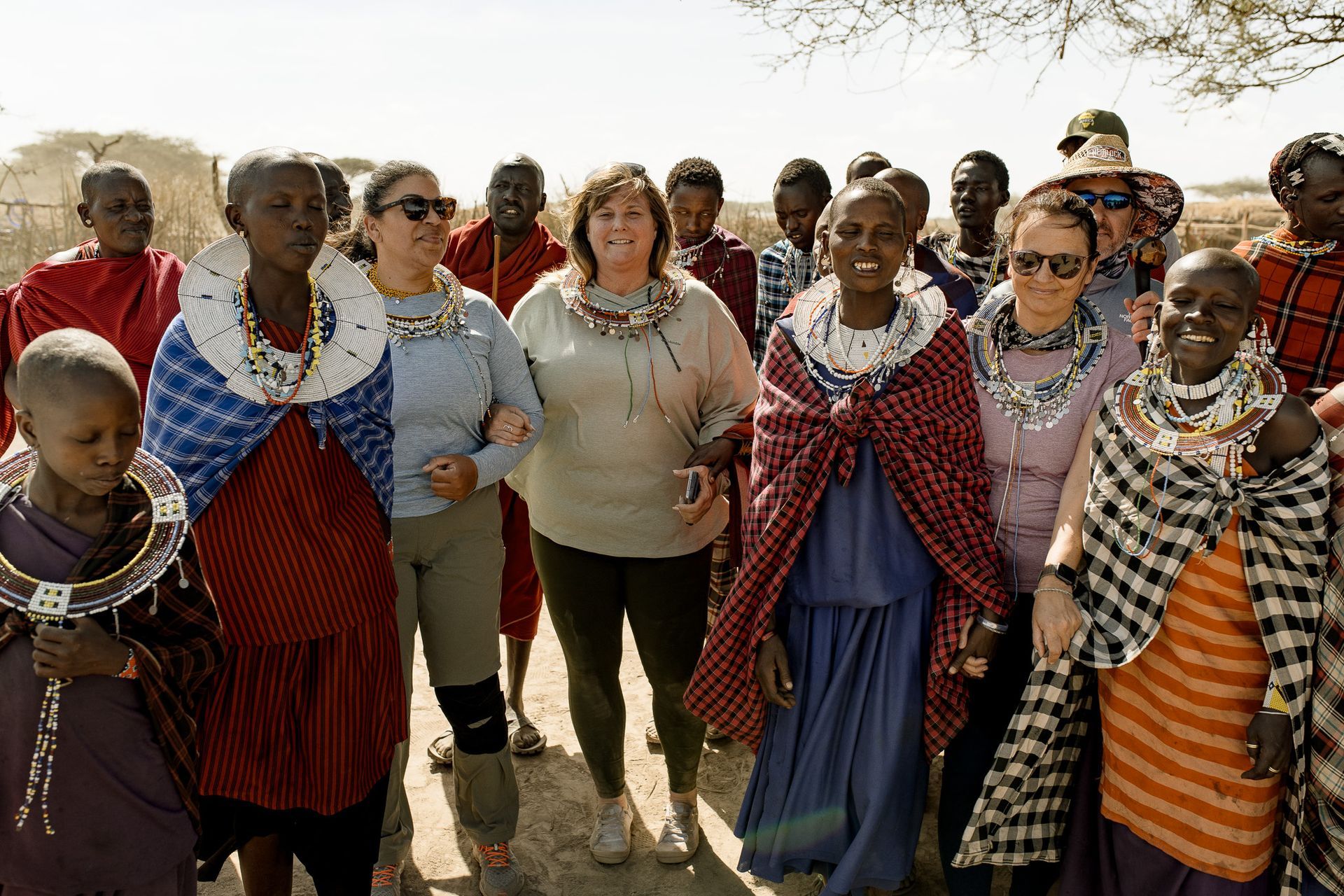 A group of people are standing next to each other in a field.