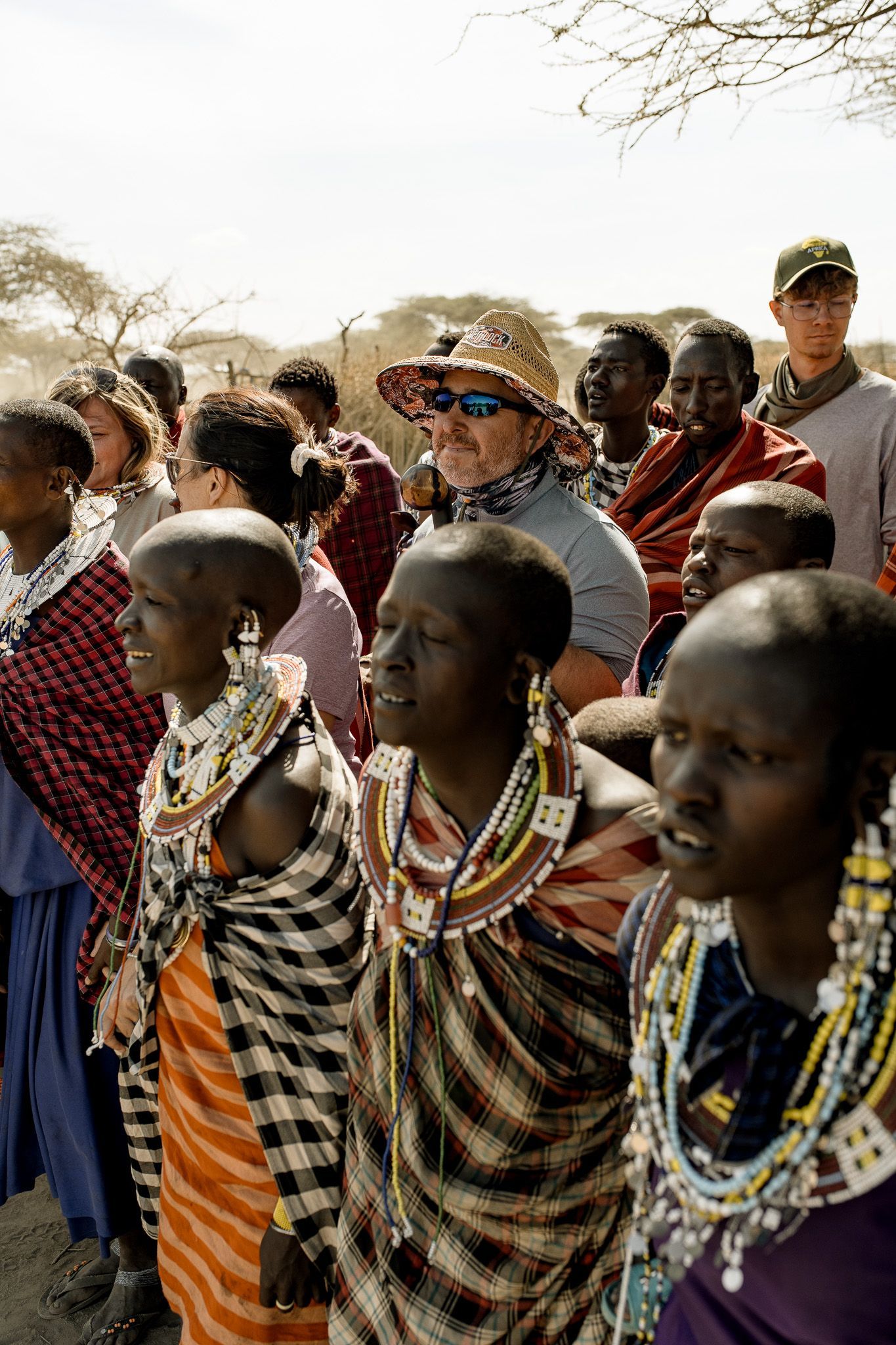 A group of people are standing next to each other in a line.
