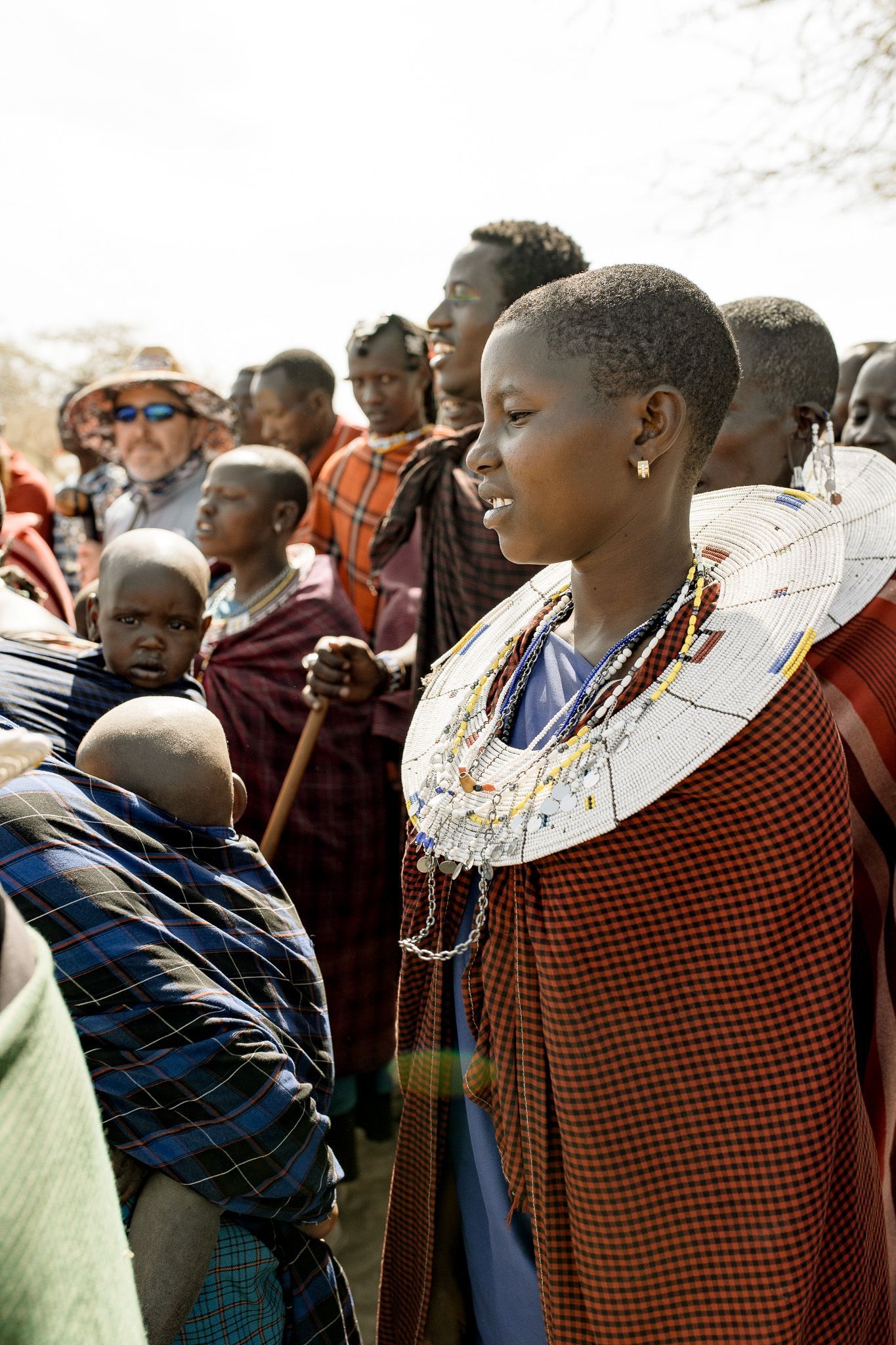 A woman is standing in a crowd of people.