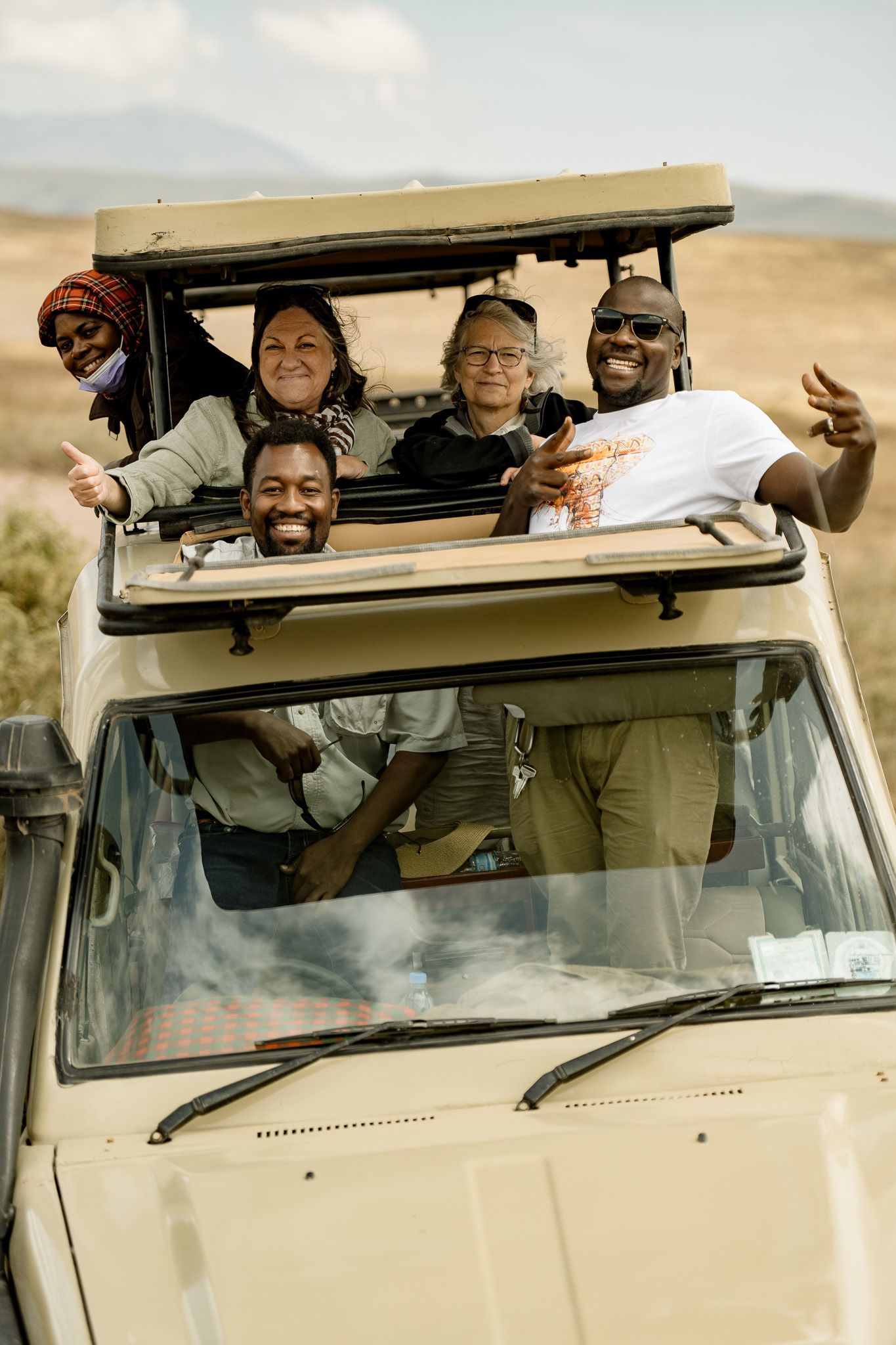A group of people are riding in a jeep.