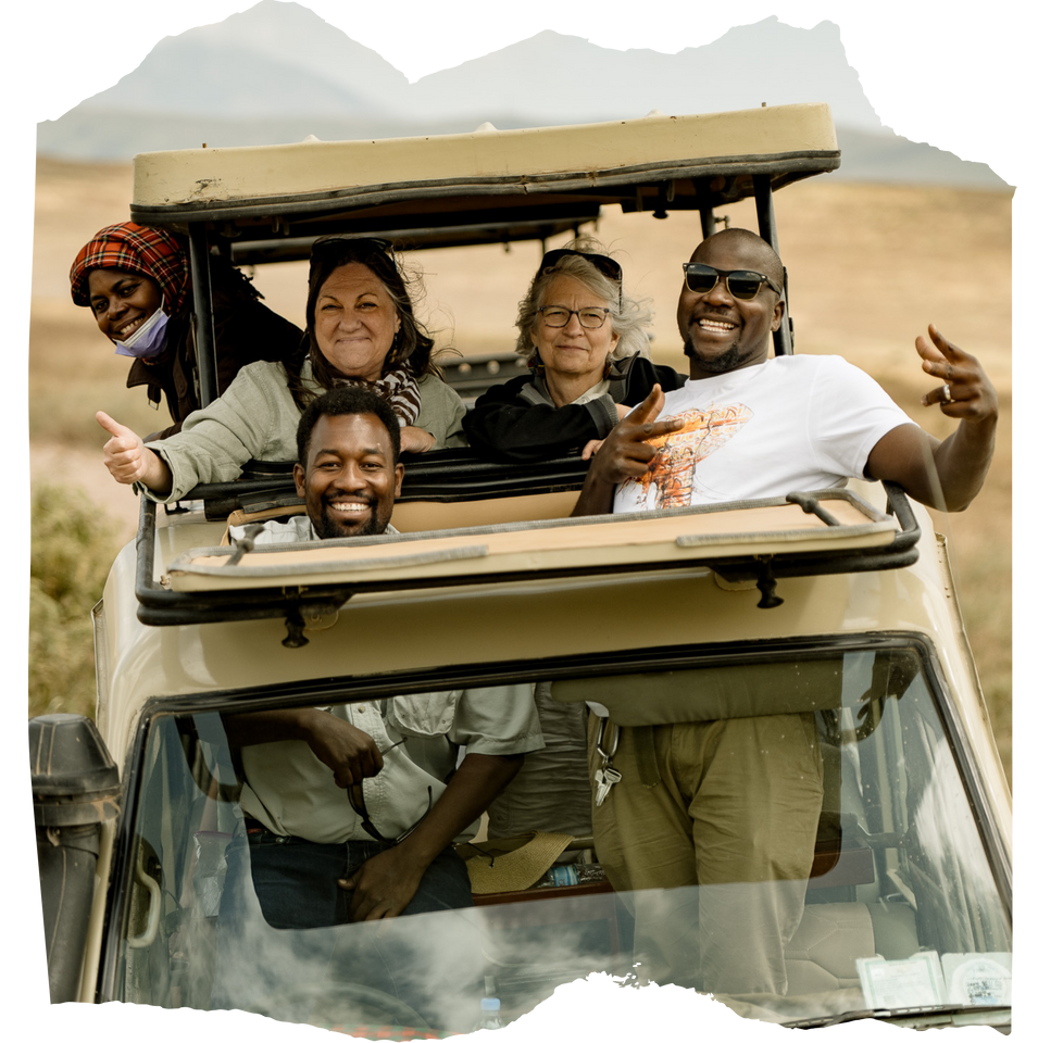 A group of people are sitting in a jeep and smiling