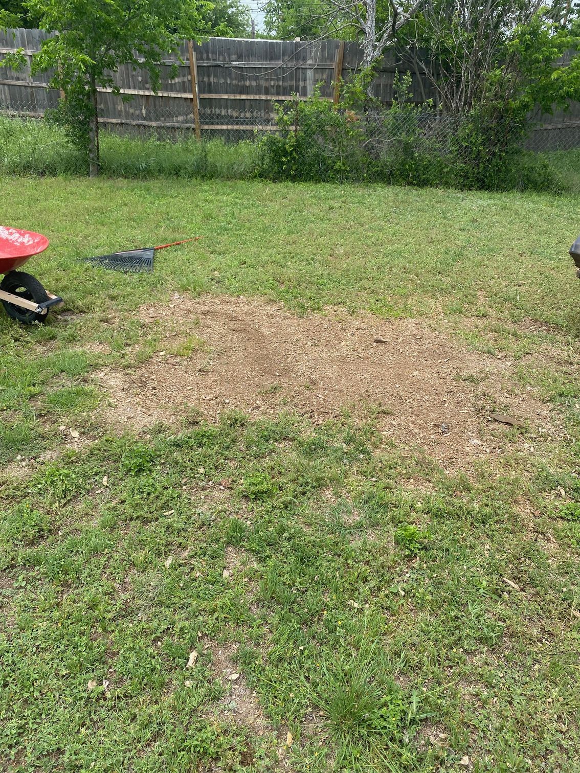 A person is holding two different types of dirt in their hands.