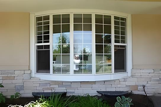 A large bay window on the side of a house