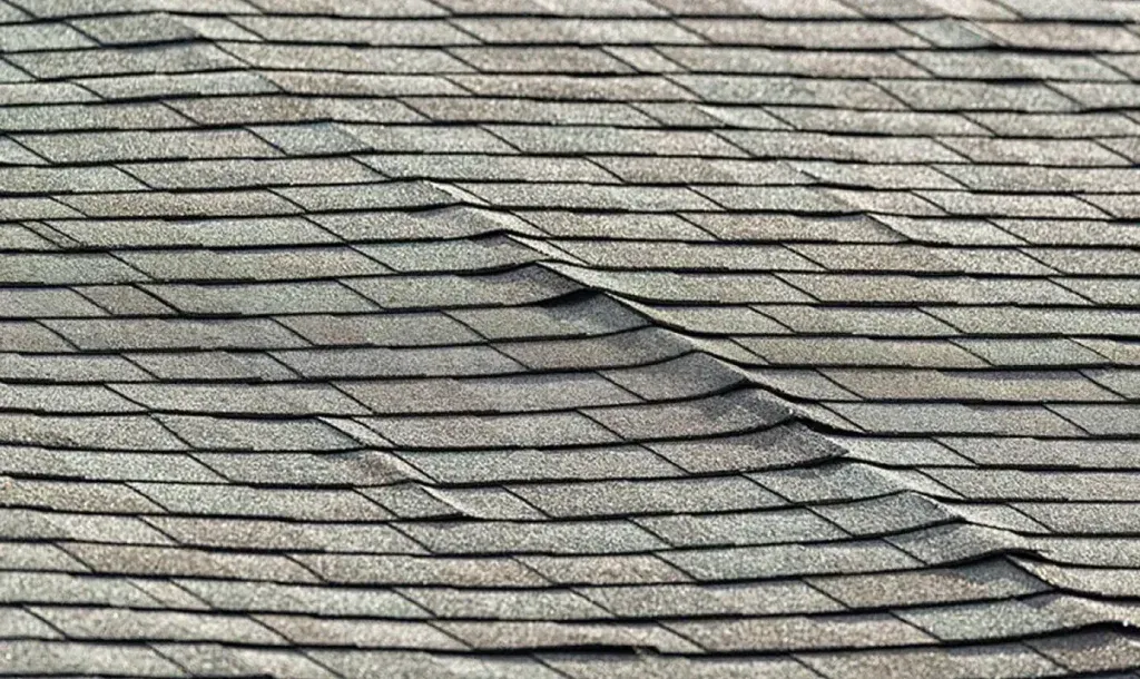 A close up of a roof with a lot of shingles missing.