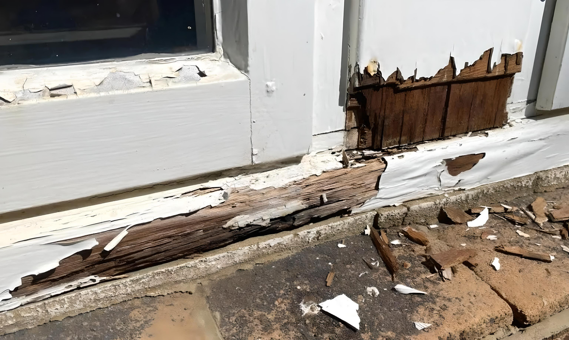 A window with peeling paint is sitting on a brick sidewalk.