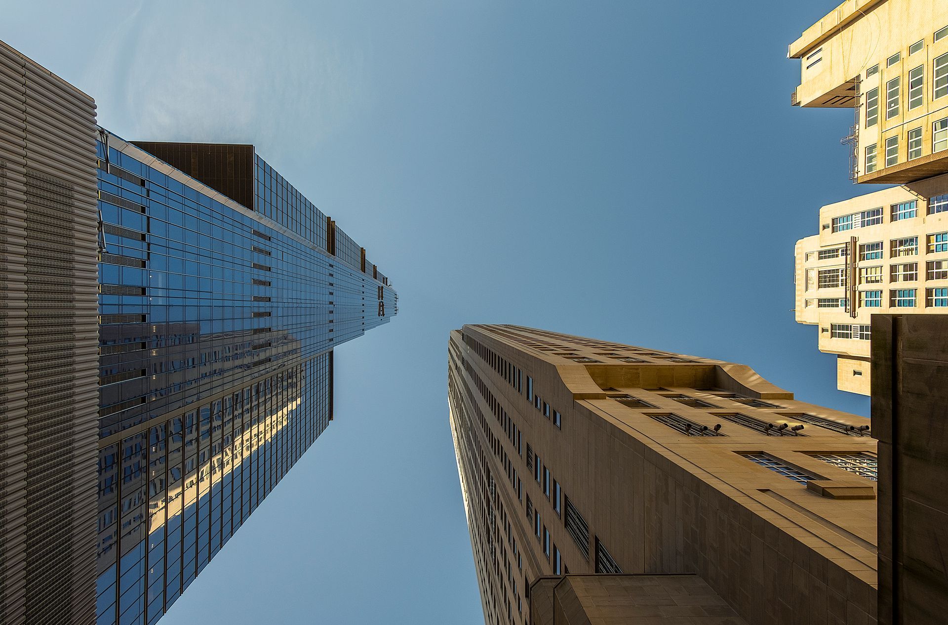 Looking up at a tall building with a blue sky in the background