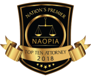 Gold and black shield-shaped award with scales of justice and banner reading "TOP TEN ATTORNEY 2018."
