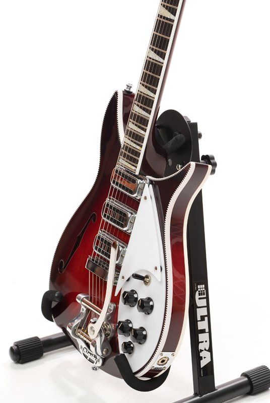 A guitar is sitting on a stand that says ultra