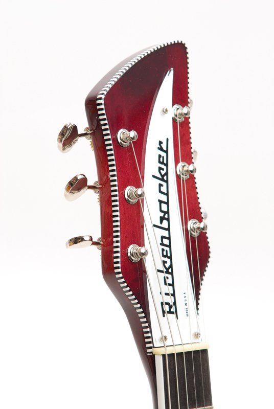The headstock of a red rickenbacker electric guitar