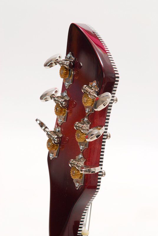 A close up of a guitar headstock on a white background