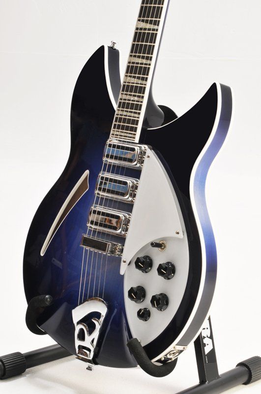 A blue and black guitar is sitting on a stand