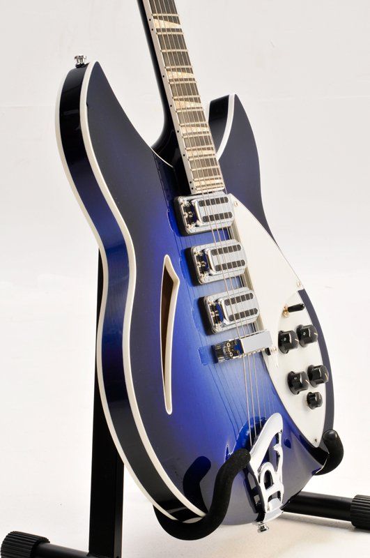 A blue and white guitar is sitting on a stand