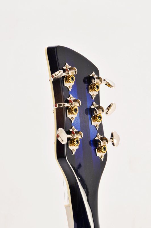 A close up of the headstock of a guitar on a white background.