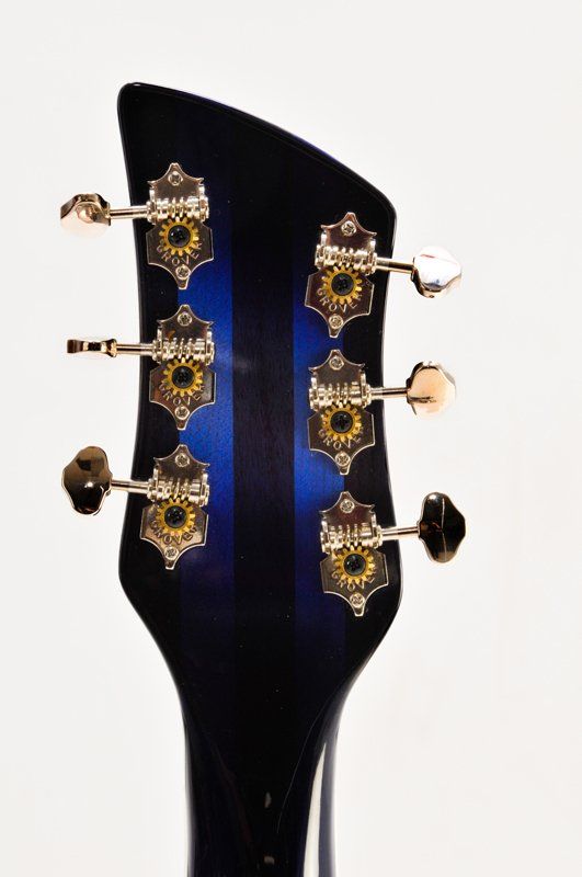 A close up of a guitar headstock on a white background