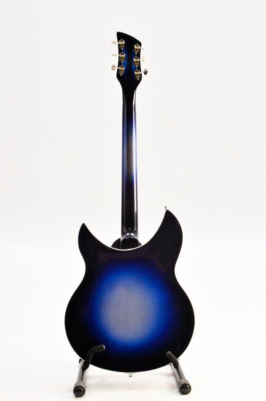 A blue electric guitar is sitting on a stand on a white background.
