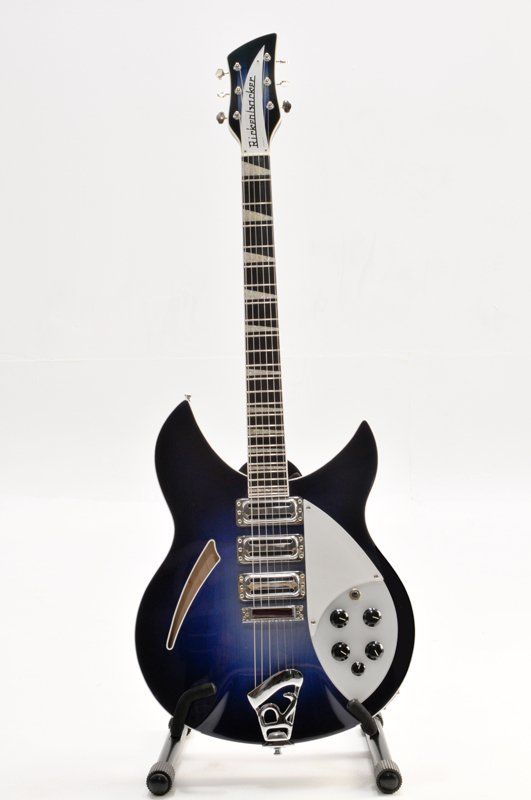 A blue and white electric guitar on a stand
