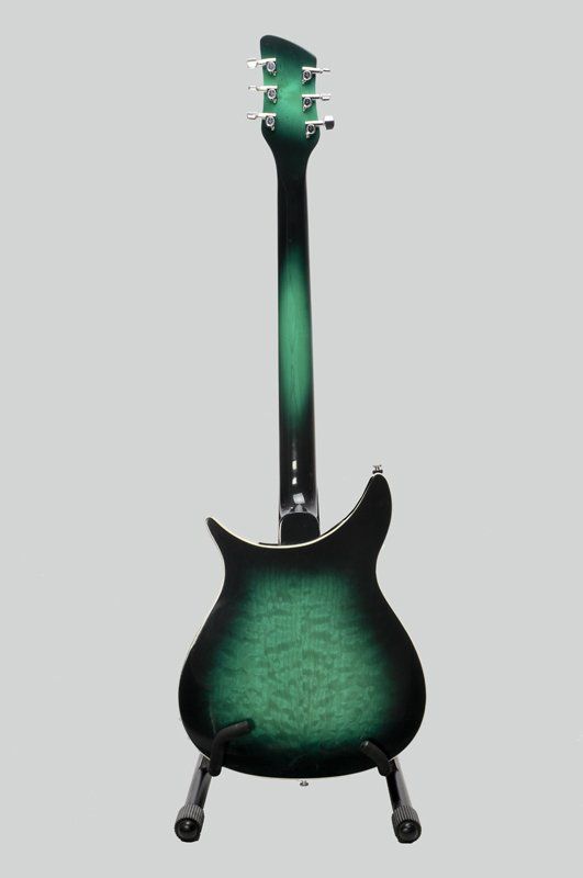 The back of a green and black electric guitar on a stand.