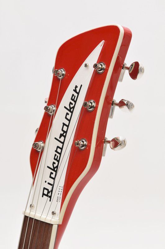A red rickenbacker guitar headstock on a white background