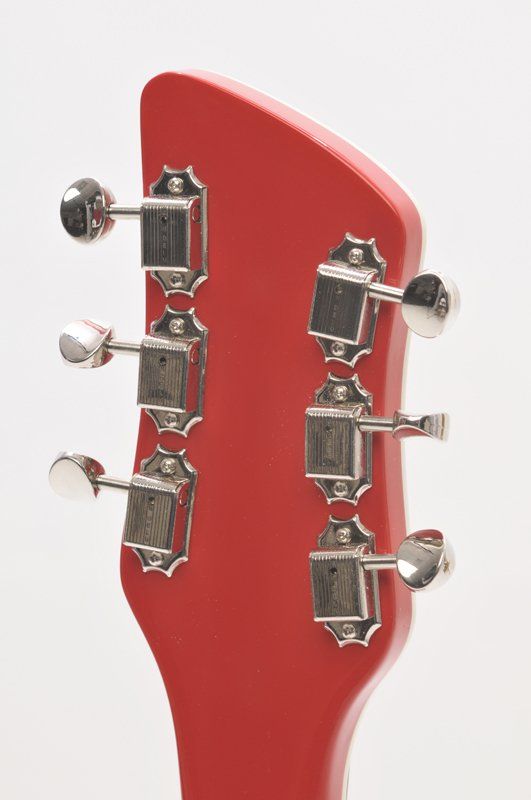A close up of a red guitar headstock with chrome tuners