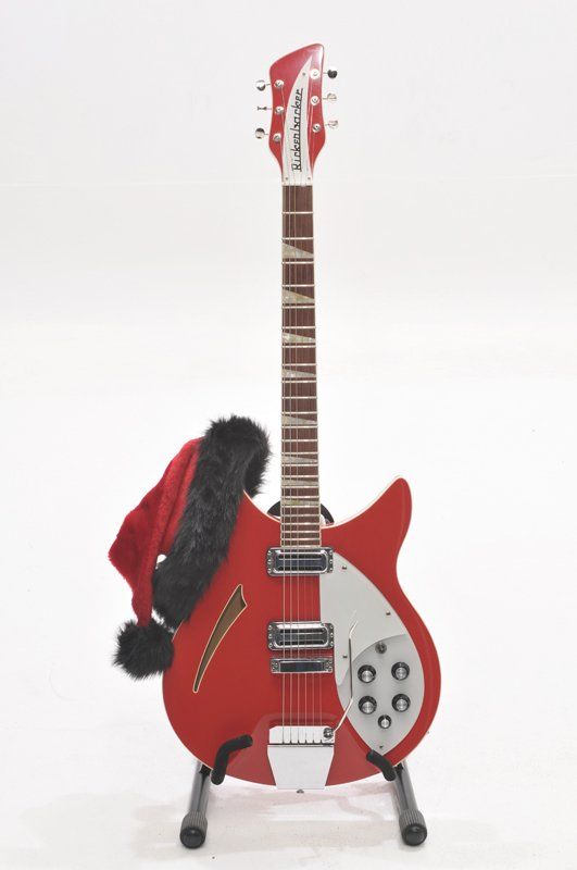 A red guitar with a santa hat on it