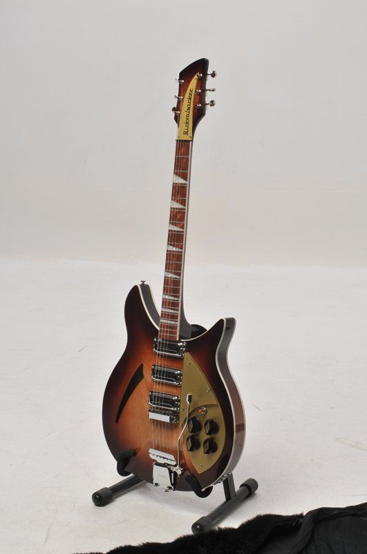 A guitar is sitting on a stand against a white background