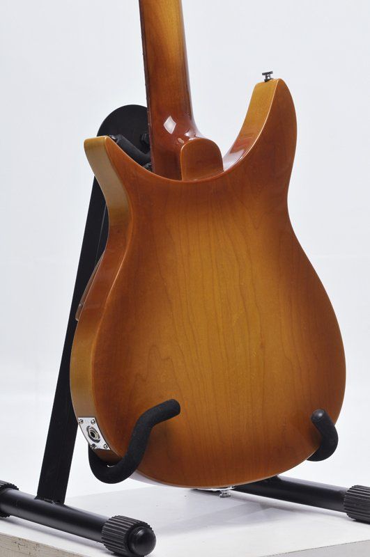 The back of a guitar is shown on a stand