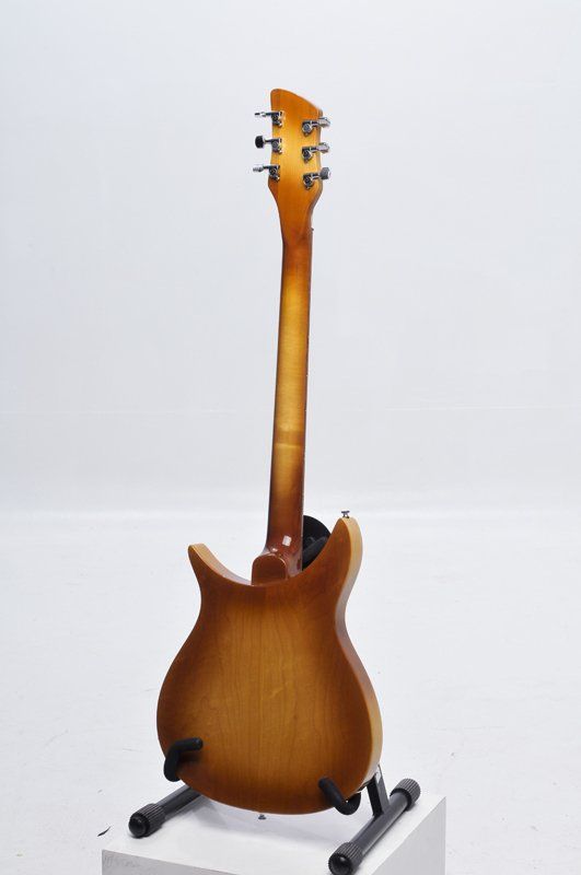 The back of a guitar is shown on a stand